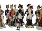seven figurines of different sizes and colors of soldiers