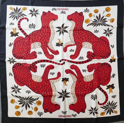 a red and black scarf with leopards and flowers on it