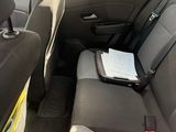 the back seat of a car with a laptop and a book in it