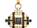 a close up of a gold cross with a black and white cross on it