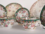 four cups and a saucer sitting on a table