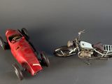 two toy cars that are next to each other on a table
