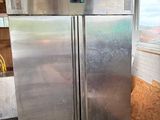 a stainless steel refrigerator inside of a building