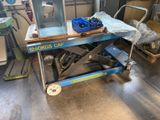 an image of a scissor sitting on a table in a garage