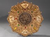 a gold plate with a picture of a man and a woman on it