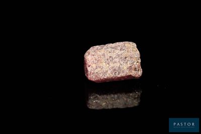 a close up of a piece of rock on a black surface