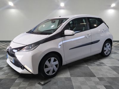 a picture of a white toyota prius parked on a checkered floor