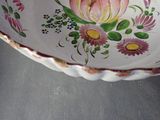 a bowl with a flower design on it on a table