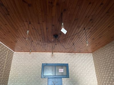 a blue door in a room with a wooden ceiling