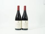 deux bouteilles de vin rouge posées l'une à côté de l'autre sur une surface blanche