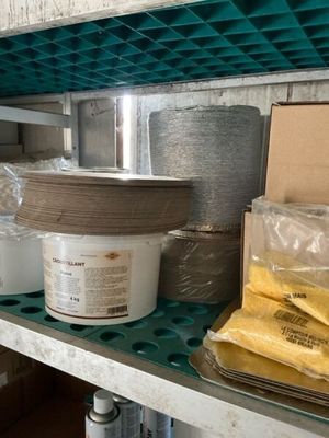 many pots and pans on the shelves in the kitchen