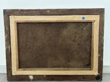 an old wooden picture frame with a blue dot on it
