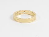 a close up of a gold ring on a white surface