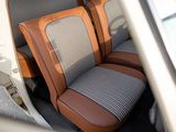 two seats in the back of a car that are grey and brown