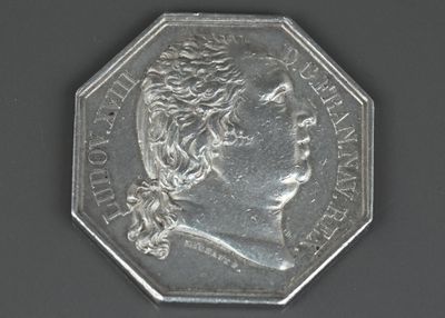l'image d'une pièce d'argent sur laquelle figure le visage d'une femme