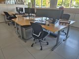 many computers on the desks in this office