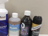 bottles of cleaning products are sitting on a shelf in a bathroom