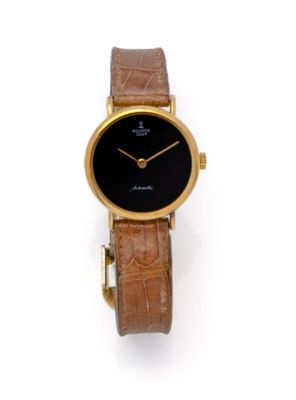 an image of a gold wrist watch with a black dial