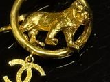 gold plated pendant with a dog and a pearl bead