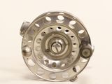 a close up of a fly reel on a white background