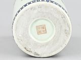 a close up of a vase on a table with a white background