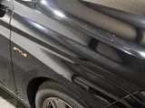 an image of a black car parked on the side of the street