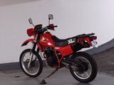 a red motorcycle that is parked in a garage