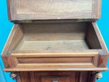 a wooden cabinet with a drawer on top of it