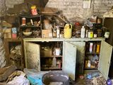 a dirty kitchen with a lot of clutter on the floor