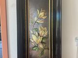 a picture of a painting on the wall next to a vase