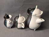 three teapots that are sitting next to each other