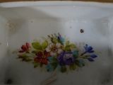 a close up of a plate with flowers painted on it