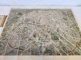 an old map of the city of paris on display on a table