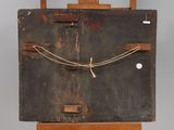 an old wooden box with a rope around it