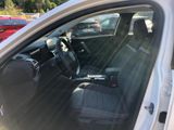 the interior of a white car with the sun shining through the window