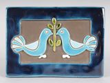 two birds that are sitting on a blue plate