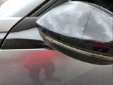 a reflection of a person in the side mirror of a car