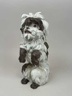 a figurine of a dog sitting on its hind legs