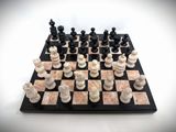 a black and white chess board with chess pieces on it