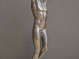 statue of a man holding his head in his hands on a table