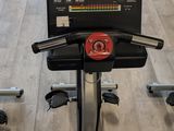 a row of exercise bikes in a gym room