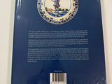 the back cover of a blue and white plate with a picture of a man on a horse