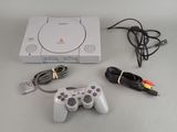 a video game console with a game controller next to it