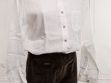a white shirt and brown pants on a mannequin stand