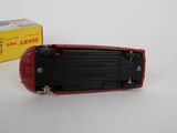 a red toy car sitting next to a yellow box