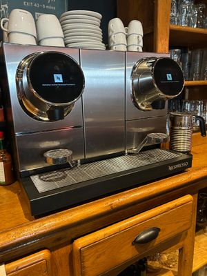 a coffee machine sitting on top of a wooden counter