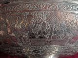 a silver bowl with a design on it on a table