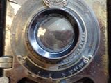 a close up of an old camera with a lens on it