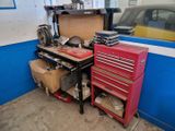 a garage with a workbench, tool chest, and other tools