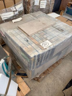 many boxes and packages sitting on a pallet in a warehouse